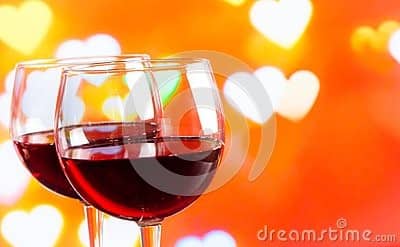 Two red wine glasses on hearts
